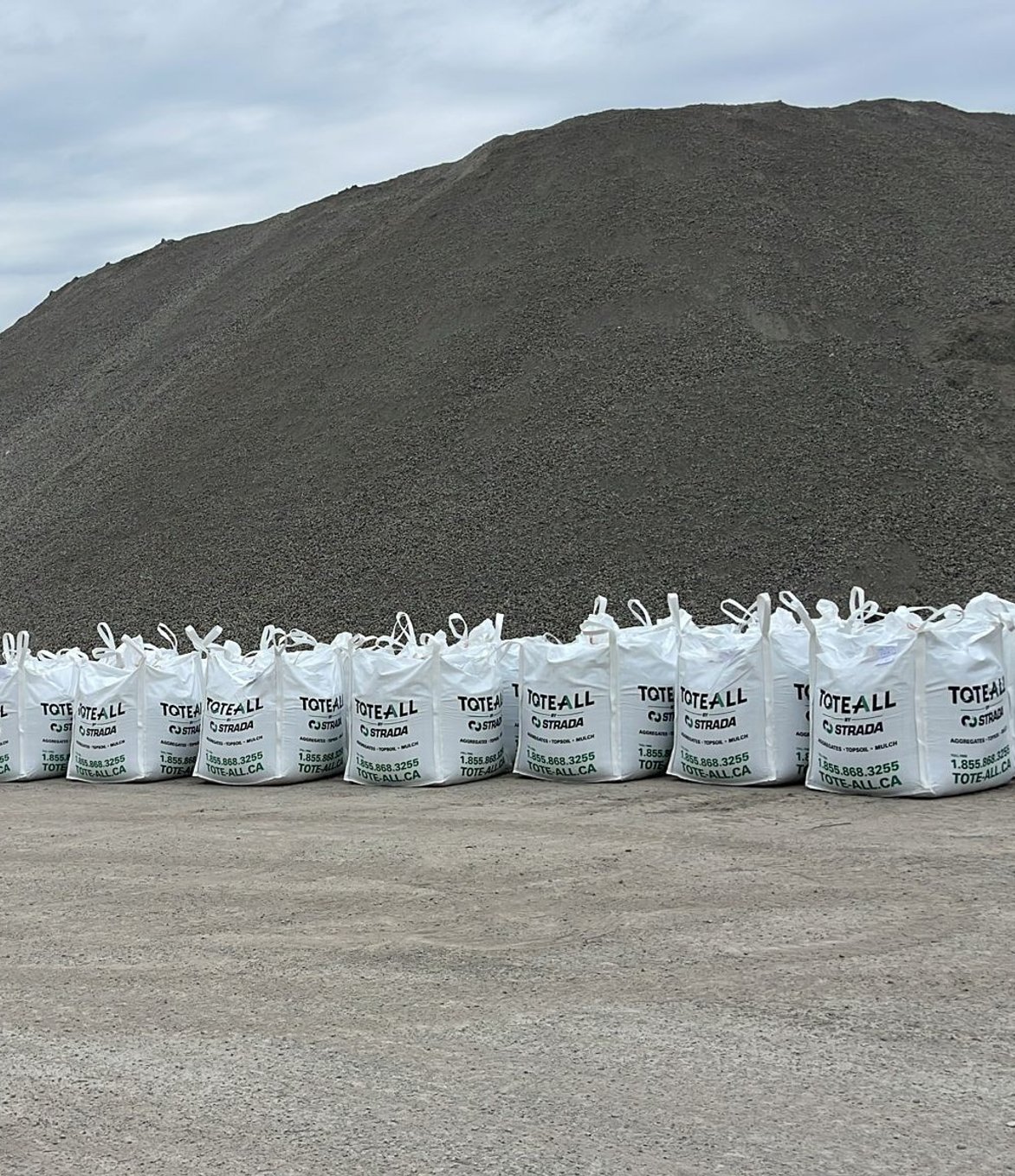 an aggregate silo with mounds in front of it